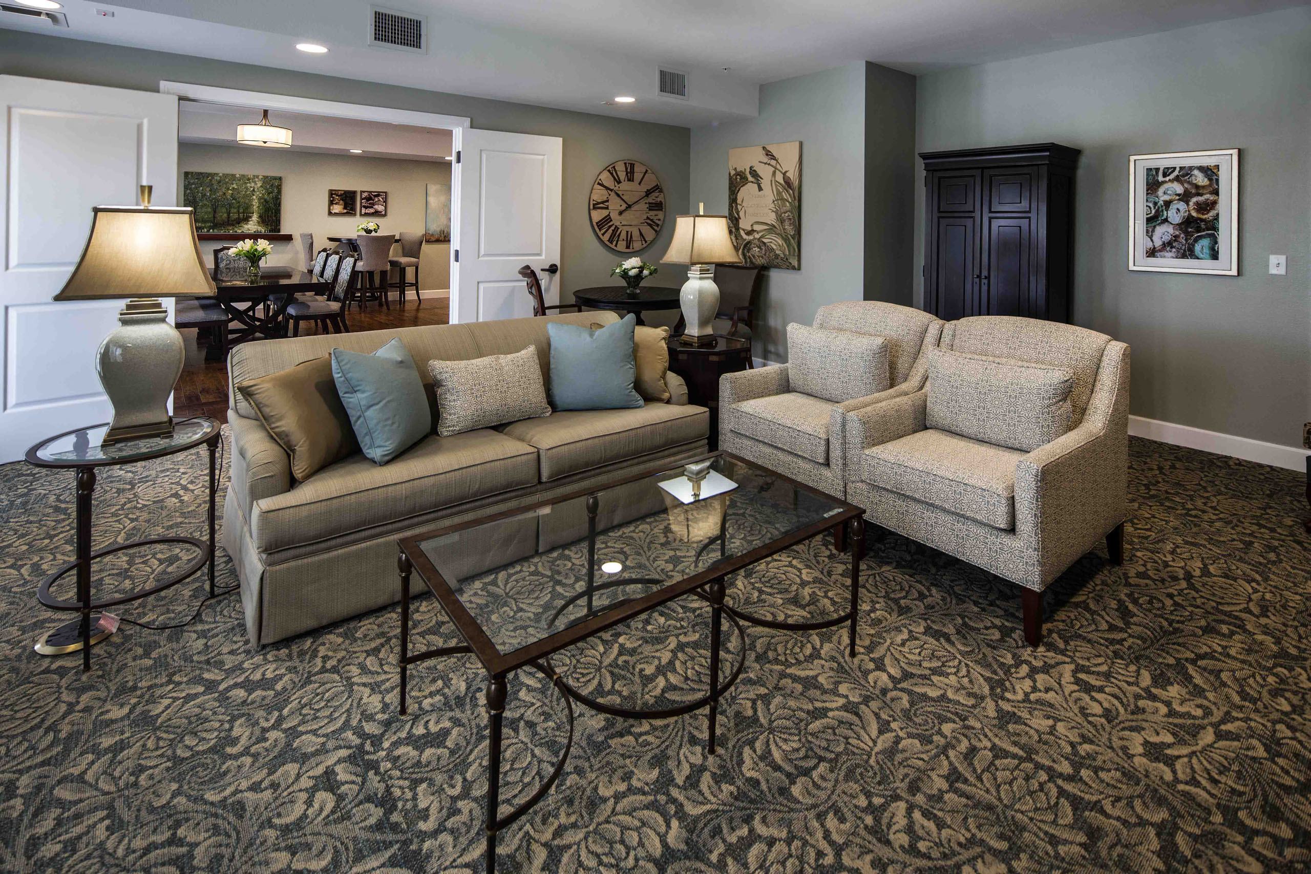 a living room with couches and a glass table